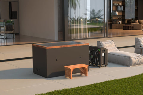 Black and orange rectangular cold plunge tub with wood trim on patio, shown with small wooden bench and cooling unit