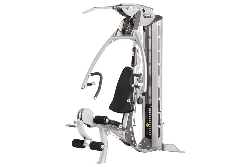 Hoist V1-Elite home gym machine with white frame, black seat and handles, featuring cable system and leg extension attachment