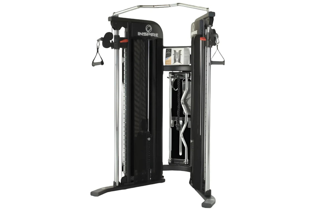 Inspire Fitness FT1 functional trainer with black panels, silver frame, dual weight stacks, and cable attachments on white ba