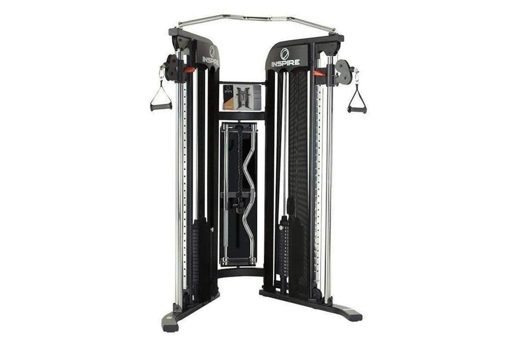 Inspire Fitness FT1 functional trainer with dual cable machine, black frame, gray top bar, and hanging handles on white backg