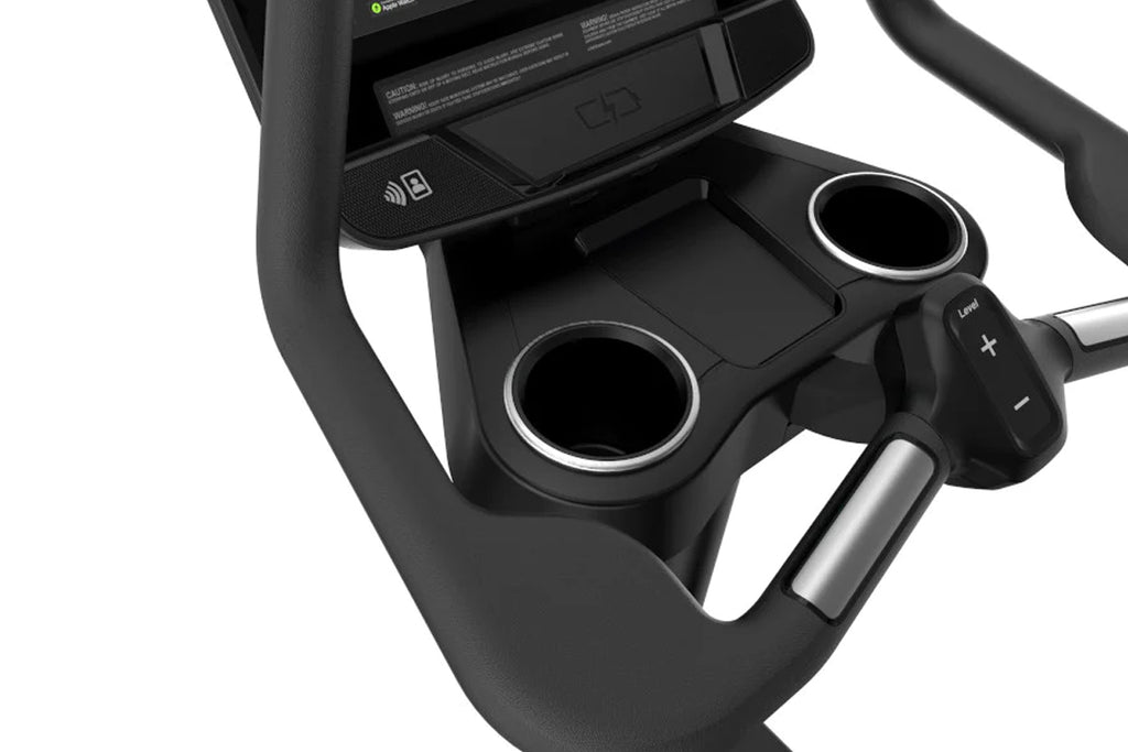Black upright exercise bike with digital display console, dual cup holders with silver trim, and control buttons on handlebar