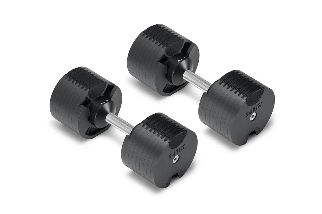 Pair of black NÜOBELL adjustable dumbbells with ridged weight plates and silver metal handles on white background