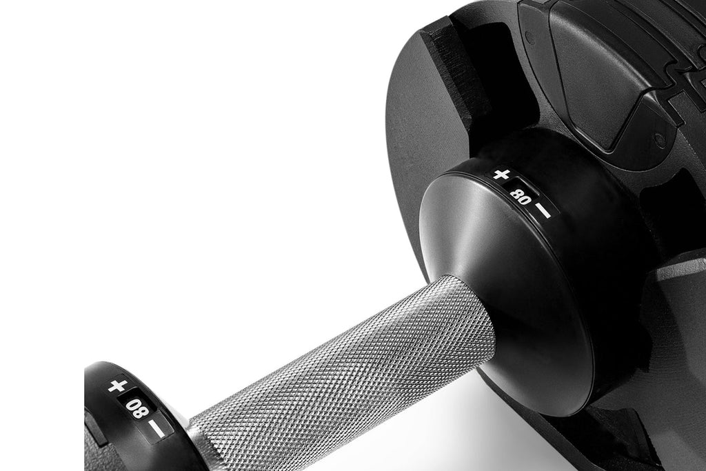 Pair of black and gray adjustable dumbbells with textured grip handles, labeled 80 lbs, on white background