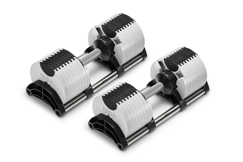 Pair of Nüobell adjustable dumbbells with white and black striped weight plates, gray handles, and black bases on white backg