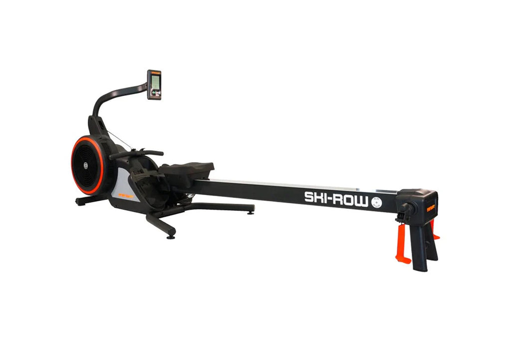 Black and orange SKI-ROW AIR+PWR rowing machine with digital display monitor, red flywheel, and extended black beam on white 