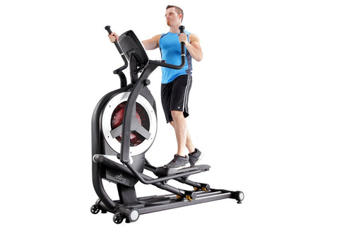 Black elliptical trainer with digital console, red accents, and extended handlebars on white background