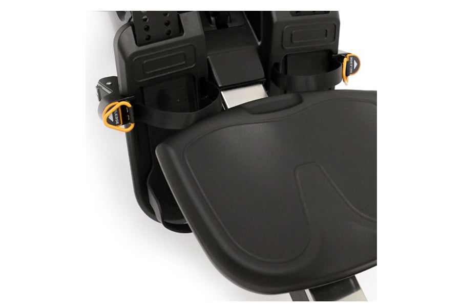 Black rowing machine with orange carabiner clips and padded footrest, overhead view on white background