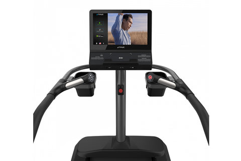 TRUE commercial stair climber with blue accent stripe, digital display console, and curved handrails on white background