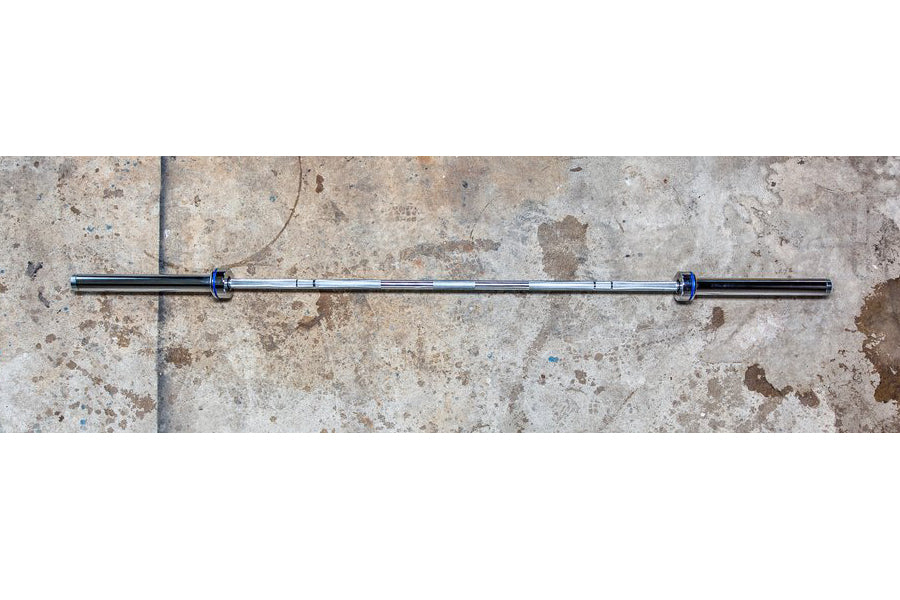 York Elite Power Bar with black steel shaft and blue collars on concrete background