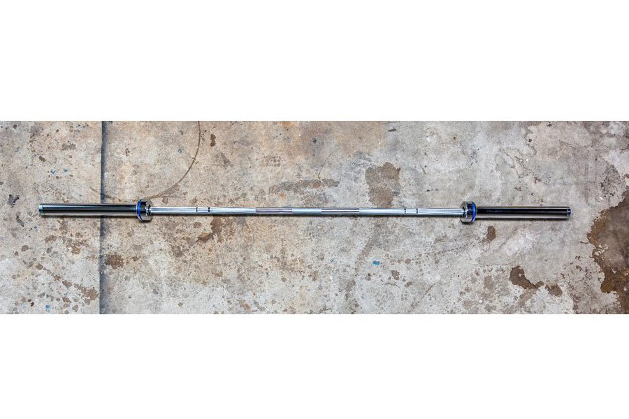 York Elite Power Bar with blue collars on concrete surface, flat lay
